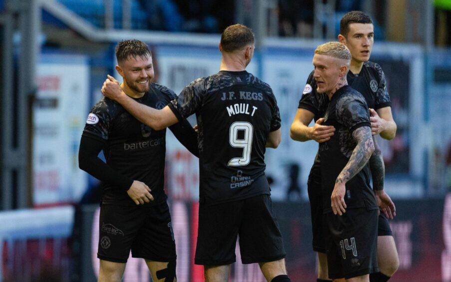 Dundee United's Glenn Middleton is congratulated