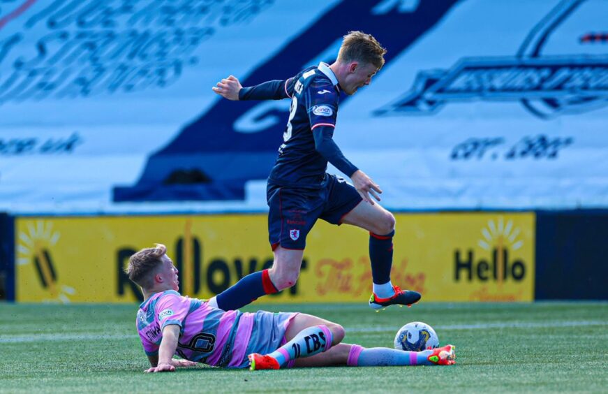 Kyle Turner tries to hurdle a tackle from the sliding Ben Stanway during Raith Rovers' draw with Partick Thistle.
