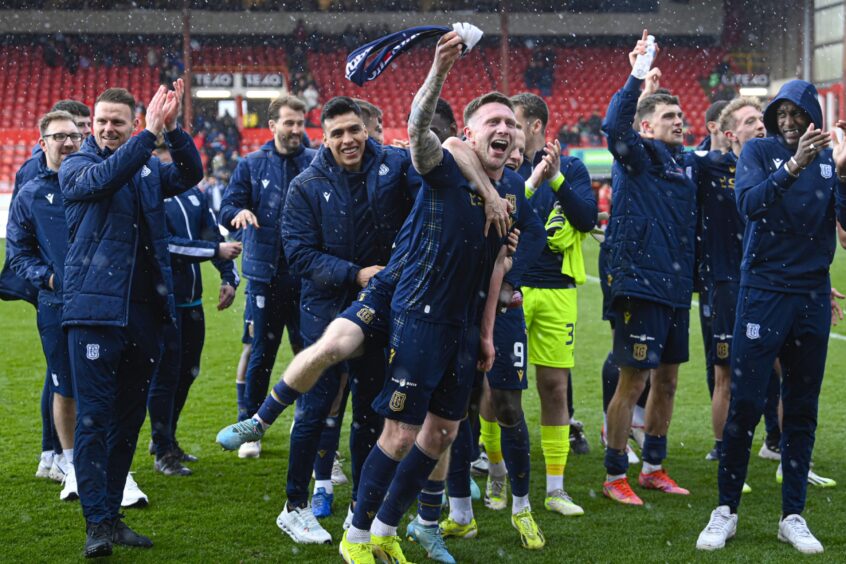 Dundee players celebrate in front of fans at full-time. Image: SNS