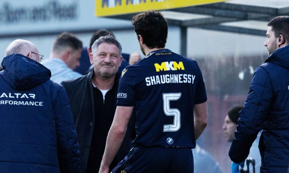 Dundee boss Tony Docherty consoles Joe Shaughnessy as he leaves the pitch after picking up his knee injury