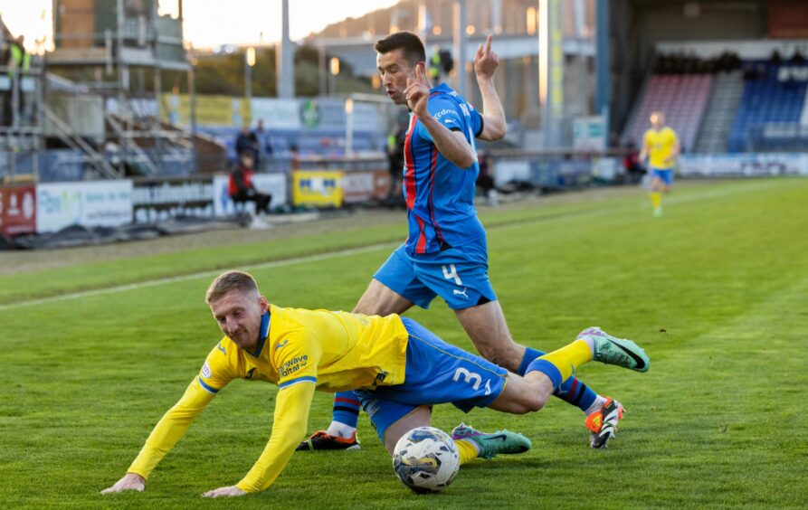 Raith Rovers defender Liam Dick is sent sprawling by Inverness defender Cammy Kerr.