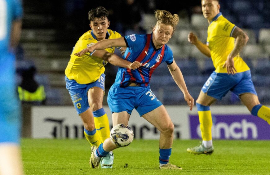 Raith Rovers defender Dylan Corr battles for the ball with Inverness striker Alex Samuel.