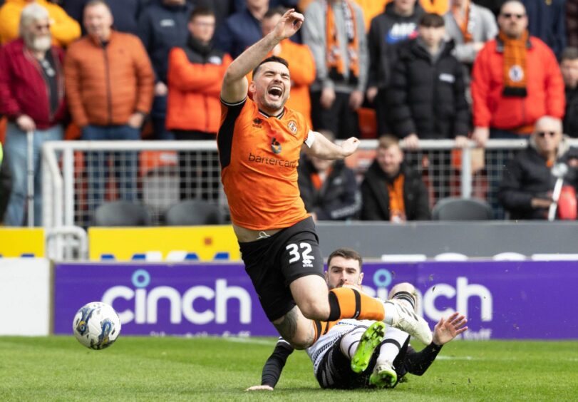 Dundee United's Tony Watt hits the deck under attention from Ayr United