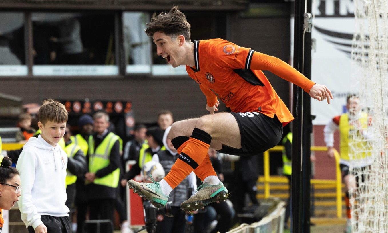 Chris Mochrie jumps ove the advertising hoardings after he scores for Dundee United