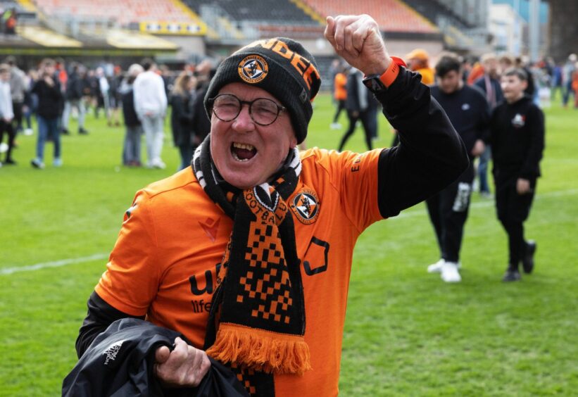 One United fan makes the most of the moment as the Tangerines effectively seal promotion.
