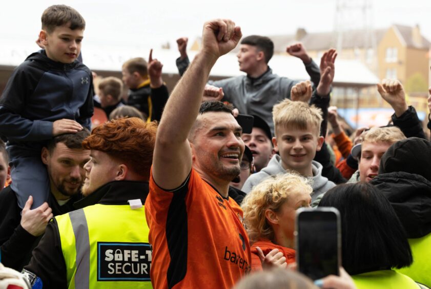 Dundee United Tony Watt is surrounded by fans