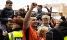 Dundee United Tony Watt is surrounded by fans.