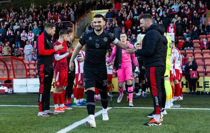 Tony Watt leads Dundee United out to a lap of honour at Aidrie