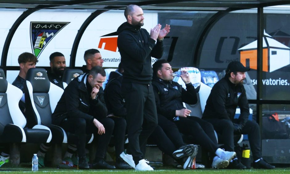 Dunfermline Athletic F.C. manager James McPake claps his teams from the dugout.