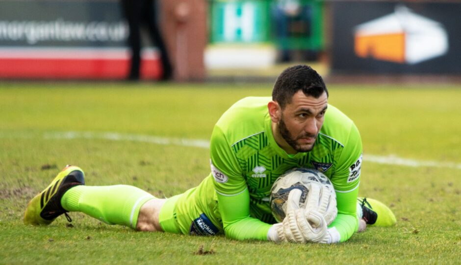 Deniz Mehmet lies on the ball after saving Billy Mckay's penalty as Dunfermline Athletic avoid relegation with a draw against Inverness.