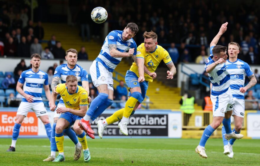 Raith Rovers defender Euan Murray jumps off the ground to head towards goal against Morton.