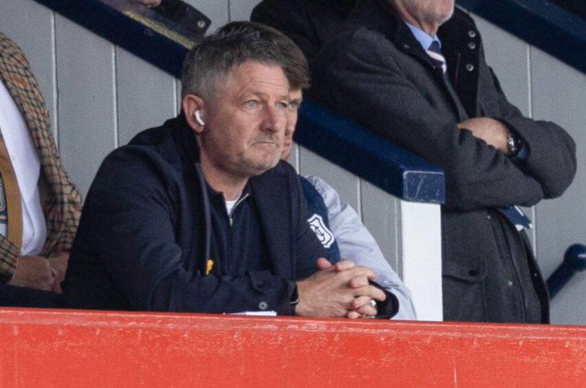 Dundee boss Tony Docherty takes his place in the stand. Image: SNS