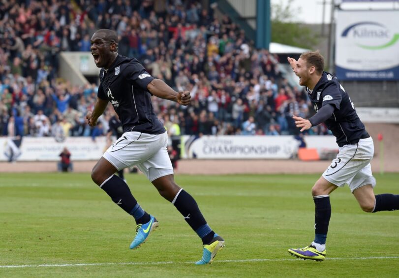 Christian Nade wheels away after scoring the first goal against Dumbarton in 2014.