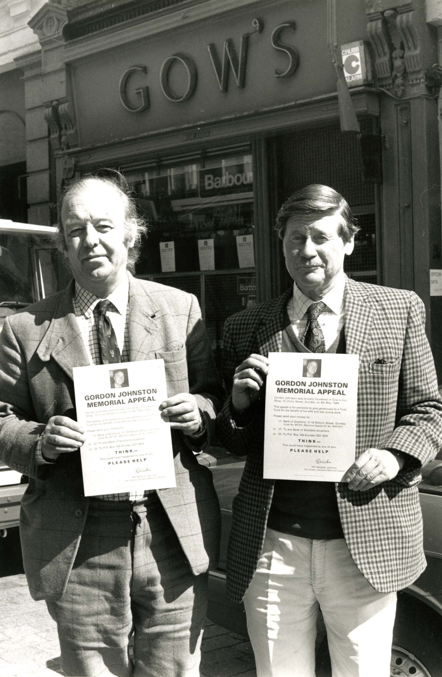 Gow's directors Pat Wilson, left, and Danvers Valentine, who raised money for the family, holding up posters appealing for information