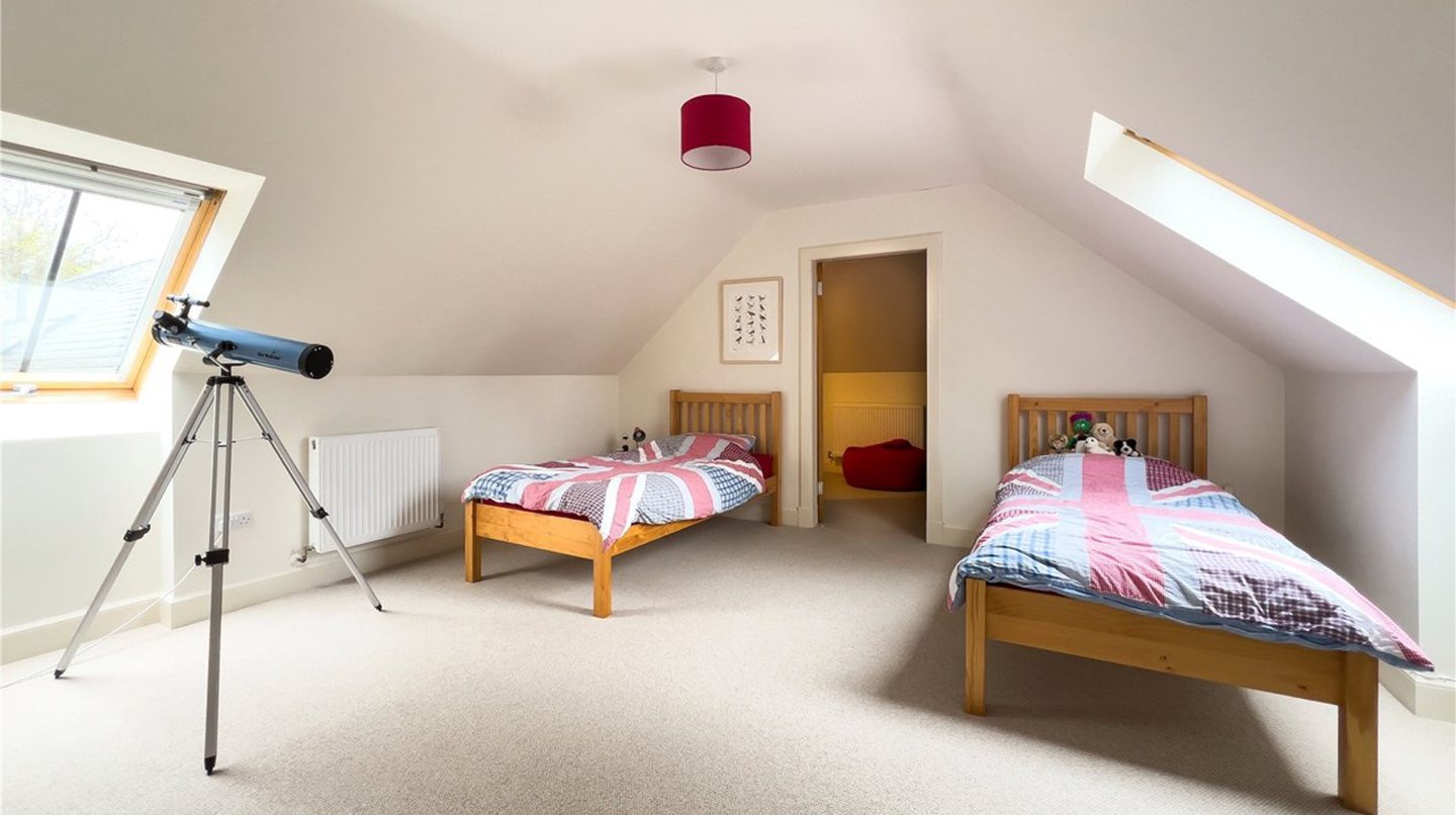 One of the upstairs bedrooms has a storage room.