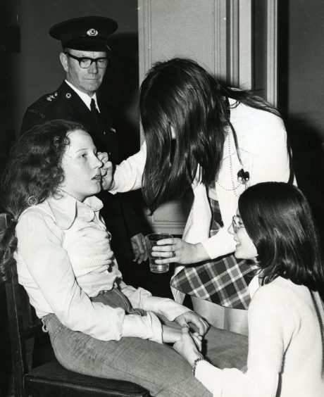 A young fan is given treatment during the Slade concert.