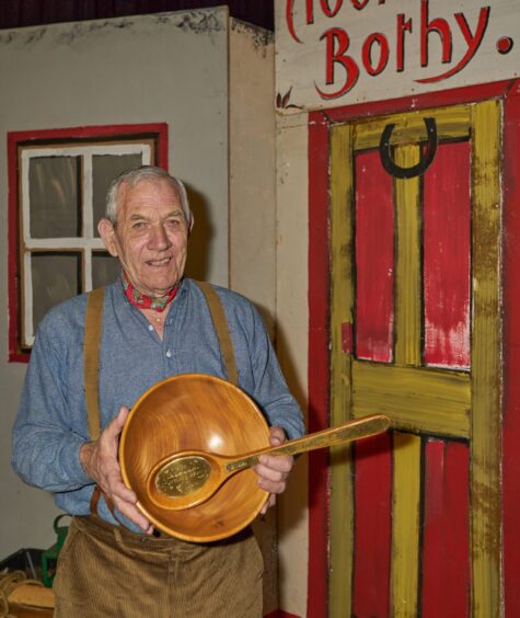 Bothy Ballad singer Joe Aitken from Kirriemuir with the Champion of Champions bowl and spurtle in 2020.