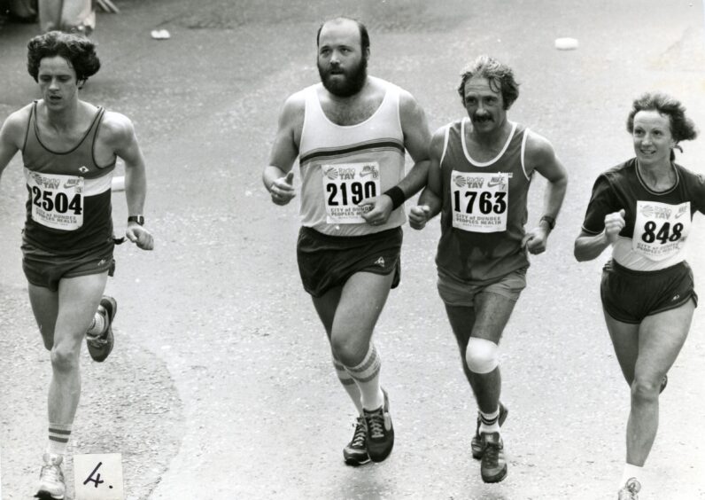 Four runners crossing the finish line in 1984. 
