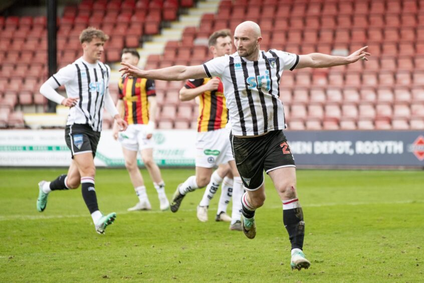 Chris Kane runs away with his arms stretched out after scoring for Dunfermline.
