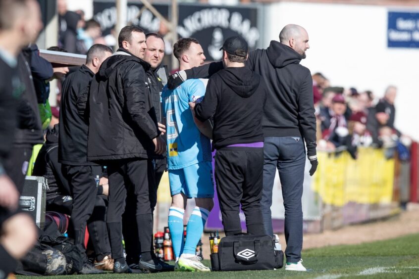 Manager James McPake puts his arm round the shoulder of Chris Hamilton as the Dunfermline player is substituted with a head knock against Arbroath.