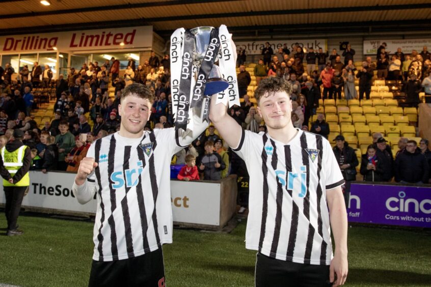 Taylor Sutherland and brother Jake Sutherland hold aloft the Reserve Cup after scoring Dunfermline's goals.