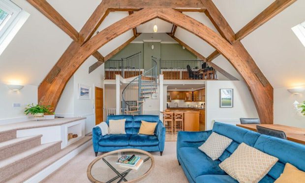 The open plan living space with original exposed beams.