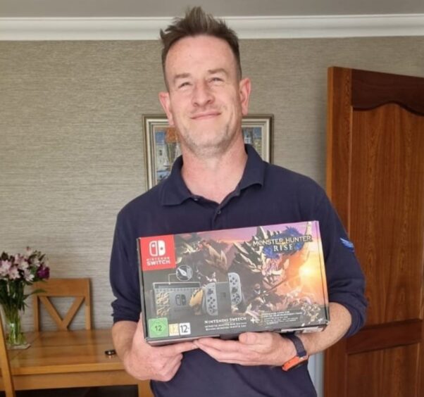 SSF Competitions winner Craig Duff holds the Nintendo Switch he won