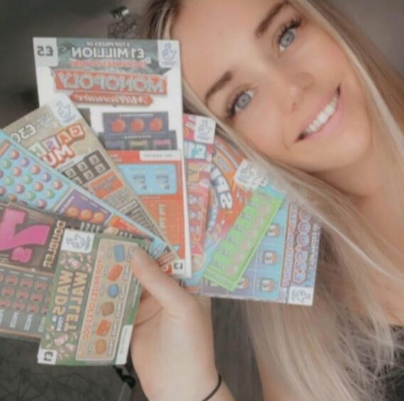 SSF Competitions winner Shan Marshall holds her winning scratch card bundle 