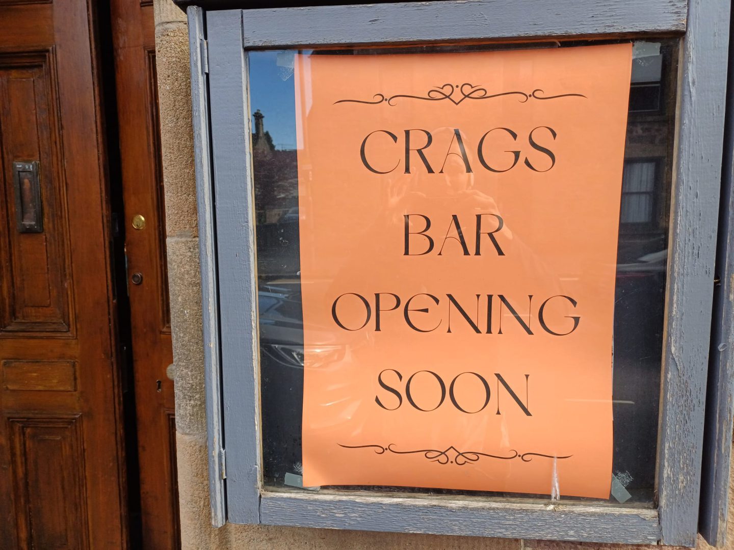 Sign indicating the reopening of the Crags Bar 