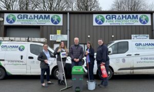 People with mops and buckets outside Graham Environmental Services premises