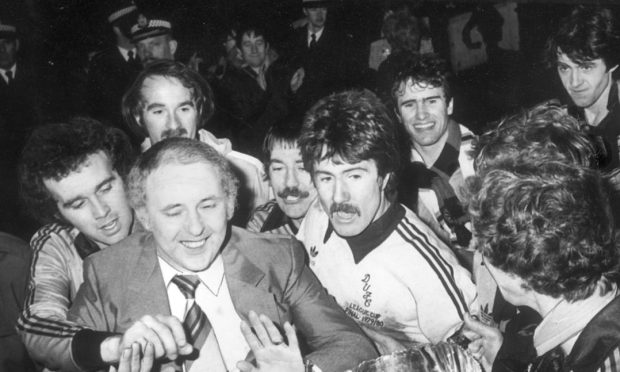 Dundee United players mob manager Jim McLean.