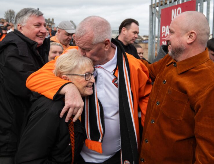 Showing the love: Two United supporters after seeing their side return to the Premiership