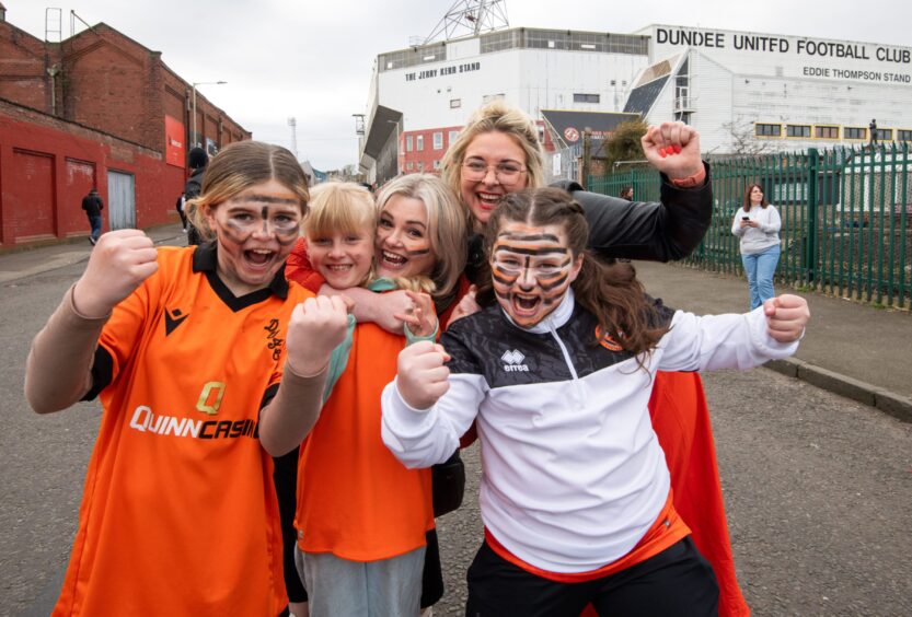 A group of United fans enjoy the win outside Tannadice