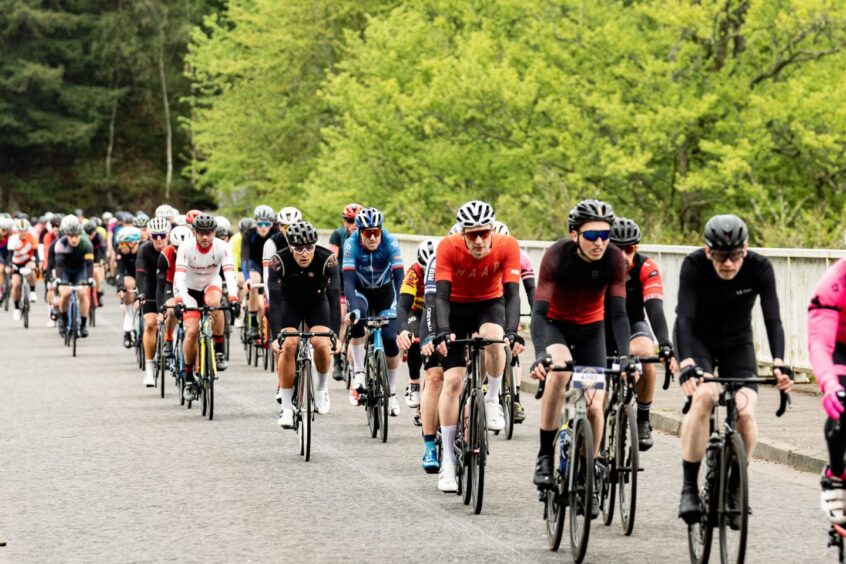 Riders traveling through Highland Perthshire in the Etape Caledonia 