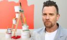 Ewan McGregor with some painting equipment.