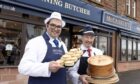 Nigel Ovens of McCaskie's (left) and Newtyle butcher Alan Pirie toast the deal. Image: Perthshire Picture Agency