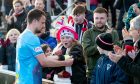 One young Dunfermline fan looks amazed as skipper Kyle Benedictus places his captain's armband on her arm.
