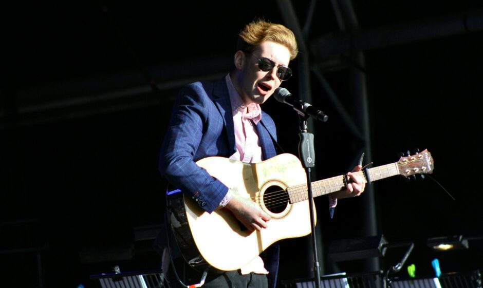 Blair Davie on stage with guitar at Glamis Castle in 2018