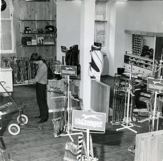 A man looks at golf equipment in the new premises of David Low on Commercial Street, Dundee, in June 1972. 