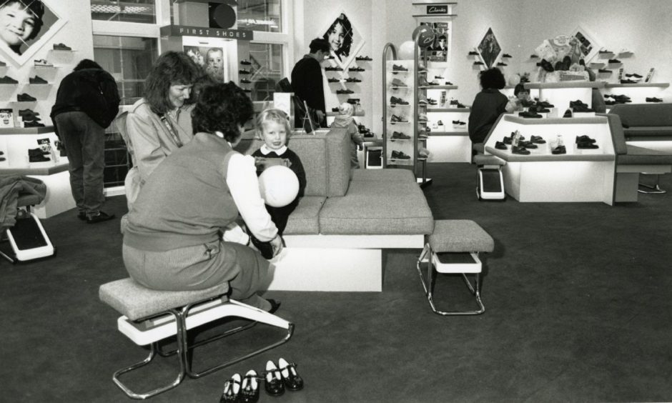 Children being fitted for shoes in the Dundee shop in 1989.