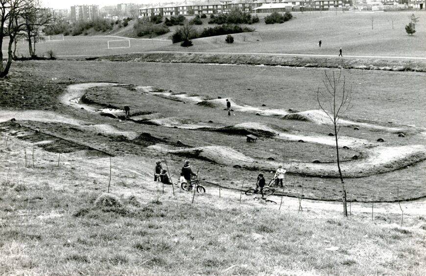 A group of young cyclists inspect the new BMX track in April 1984.