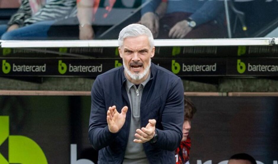 Dundee United manager Jim Goodwin applauds his side