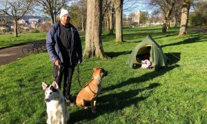 Jordan Kealey with dogs Jackson and Shyla at his makeshift campsite in Dudhope Park on Tuesday. Image: James Simpson/DC Thomson