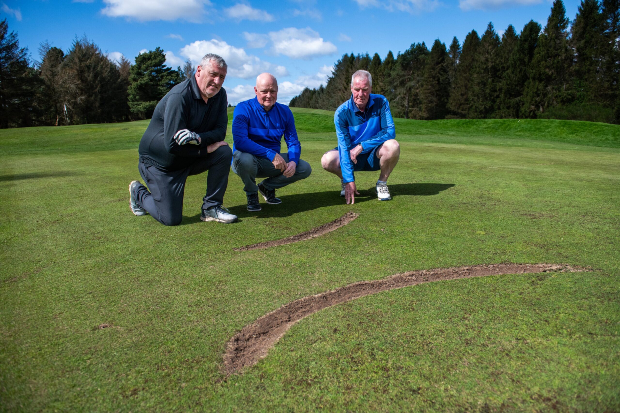 Jim Carey, Mark Campbell and Andrew McKay point out the damage on Caird Park Golf Course.