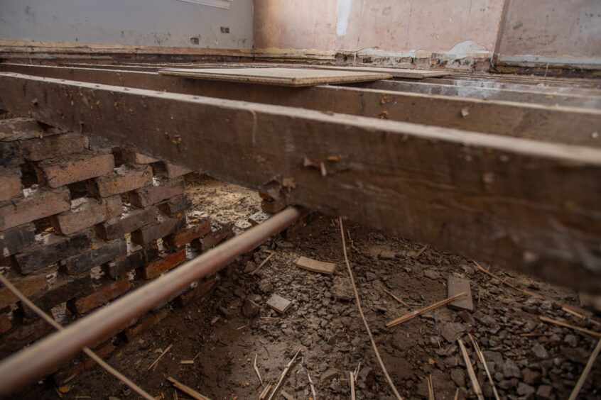 The foundations of June's home in Brechin are visible beneath what remains of the floorboards.