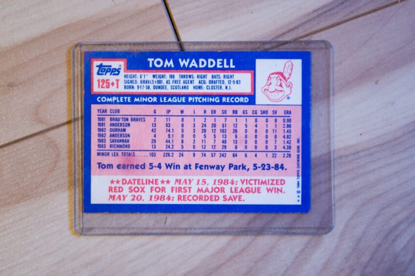 A Cleveland Indians team card showing Tom Waddell's pitching record in the minors.