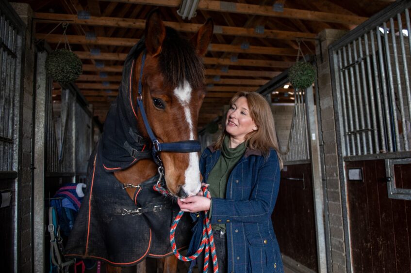 Karen Anderson with Rocky, one of the horses stabled at the centre.