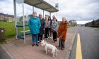 Alice Bovill and her dog 'Brodie' with some of the local residents who use the at risk bus stop outside the St Mary's Community Centre. Image: Kim Cessford/DC Thomson.