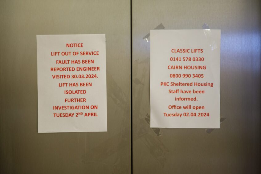 Signs advising lift is out of service and engineer has been notified