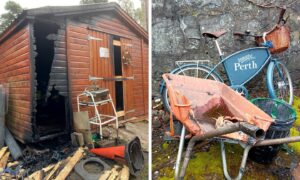 Burned out shed with melted wheelbarrow beside